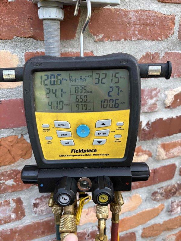 Responded to service call for low refrigerant in kitchen area HVAC system. Upon arrival, connected Fieldpiece SMAN refrigerant manifold and micron gauge to verify system pressures and diagnose refrigerant loss. System readings confirmed low R-410A refrigerant levels affecting cooling performance. Added R-410A refrigerant to manufacturer specifications to restore proper system operation. Verified pressures, temperatures, and system performance using digital diagnostic equipment. System restored to normal operating parameters and tested for proper cooling function in kitchen area.