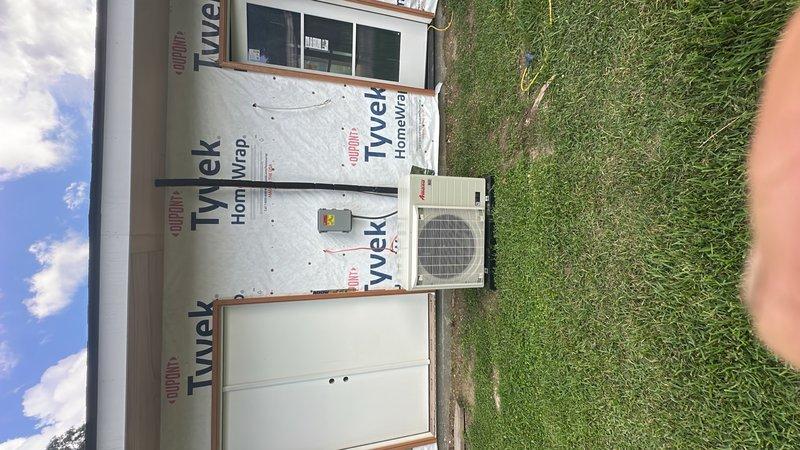 Completed installation of HVAC system including air handler unit and outdoor condensing unit. Air handler was properly mounted within framed interior space with connections made to flexible ductwork and rigid duct piping. Exterior condenser unit was installed on building exterior with appropriate electrical disconnect and protective grille. All ductwork connections were secured and system was prepared for final startup and commissioning.