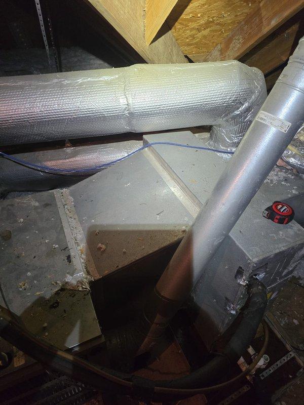 Performed second opinion evaluation on downstairs HVAC system currently experiencing refrigerant loss and inoperability. Assessed attic-installed air handler with evaporator coil (11 years old), furnace (20 years old), and outdoor condenser unit (3 years old). System is currently shut down due to low refrigerant charge. Documented existing ductwork configuration including flexible supply runs with reflective insulation and metal trunk lines. Photographed air handler installation, condensate drain assembly with PVC trap, and overall system condition showing normal dust accumulation consistent with age. Provided estimates for evaporator coil and drain pan replacement as well as complete system replacement options. Reviewed membership program benefits and service options. Upstairs system verified to be operational with adequate cooling performance at time of visit.