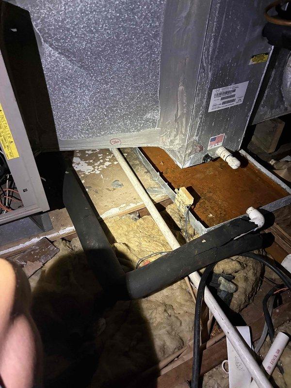 # Condensate Pump Installation with Safety Controls

Completed installation of condensate pump system with dedicated drain pan and float switch for HVAC air handler unit located in attic space. Mounted condensate pump assembly adjacent to existing air handler, ensuring proper positioning for gravity drainage from unit into pump reservoir. 

Installed dedicated safety drain pan beneath air handler to capture overflow or leak conditions. Integrated float switch into pan as secondary safety control to shut down system operation in event of primary drainage failure or pump malfunction. Wired float switch into unit control circuit to interrupt compressor operation when activated.

Routed black insulated refrigerant lines and white PVC condensate discharge piping according to manufacturer specifications. Secured all piping and tubing to floor joists using appropriate fasteners to prevent movement and ensure proper pitch for drainage. Connected condensate drain line from air handler coil to p