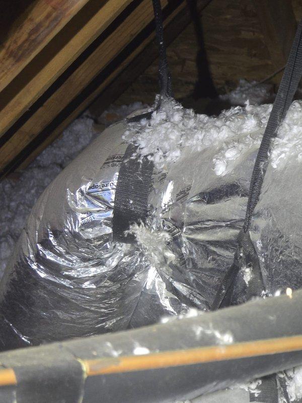 Conducted second opinion evaluation for upstairs HVAC system. Documented exterior condensing unit installation on concrete pad with electrical disconnect and conduit connections, as well as attic ductwork configuration including flexible metallic ducting with support strapping and insulation placement. Assessment completed to provide estimate for system servicing or replacement needs.