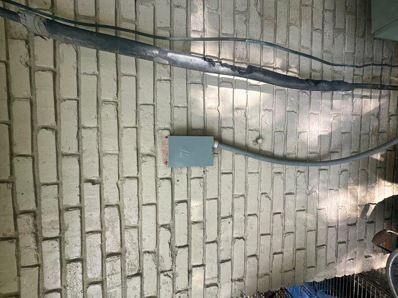Responded to after-hours emergency service call for HVAC system not producing cold air. Customer reported indoor fan running but no cooling, with previous unsuccessful service attempts by another contractor. Upon arrival, performed comprehensive system diagnostics including electrical testing at outdoor disconnect using multimeter. Verified power supply to condensing unit and checked voltage at disconnect terminals. Inspected indoor air handler unit and associated electrical connections in mechanical space. Documented equipment conditions and electrical measurements with photos for service records. System evaluated for compressor operation, refrigerant circuit integrity, and control circuit functionality to identify root cause of cooling failure.