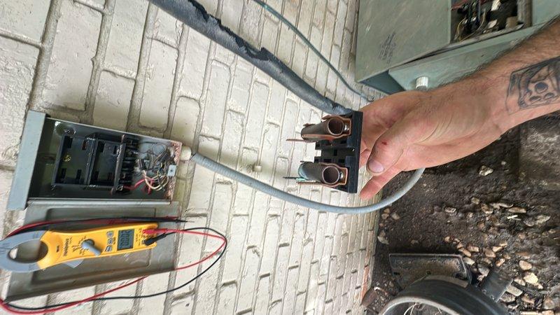 Responded to after-hours emergency service call for HVAC system not producing cold air. Customer reported indoor fan running but no cooling, with previous unsuccessful service attempts by another contractor. Upon arrival, performed comprehensive system diagnostics including electrical testing at outdoor disconnect using multimeter. Verified power supply to condensing unit and checked voltage at disconnect terminals. Inspected indoor air handler unit and associated electrical connections in mechanical space. Documented equipment conditions and electrical measurements with photos for service records. System evaluated for compressor operation, refrigerant circuit integrity, and control circuit functionality to identify root cause of cooling failure.