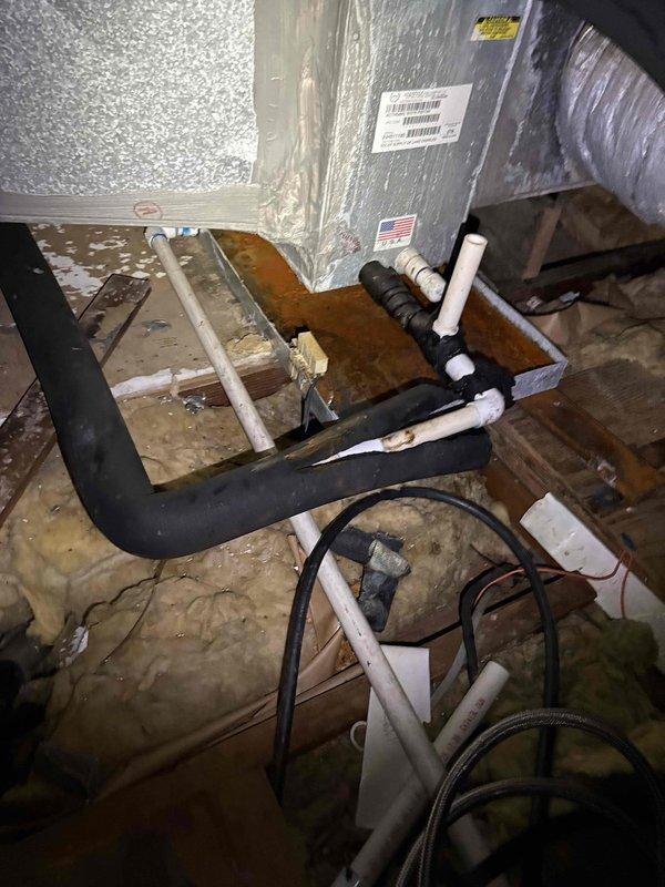 Responded to customer callback regarding HVAC system concerns. Performed thorough inspection of attic-mounted air handler unit and associated ductwork. Documented current installation conditions including metallic supply ductwork, flexible return duct connections, and condensate drain piping. Verified equipment labels and specifications were intact. Assessed insulation placement around ductwork and between floor joists. Photographed system components to provide visual documentation of current installation status and address customer's questions about the ongoing situation.