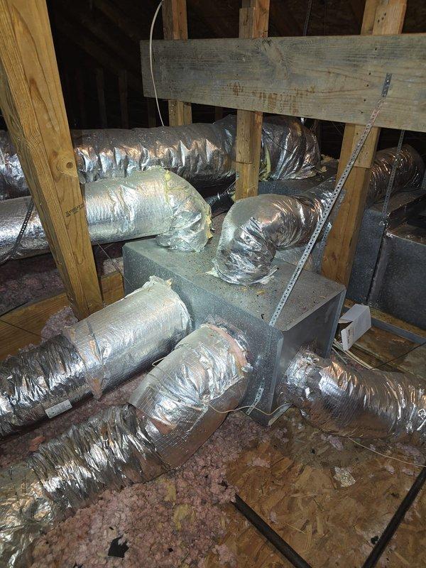 Conducted attic assessment for HVAC system evaluation. Inspected existing ductwork configuration, including central plenum distribution box and flexible insulated branch ducts running throughout the attic space. Documented current system layout, structural framing, and insulation conditions. Prepared estimate for window unit installation as discussed with customer.