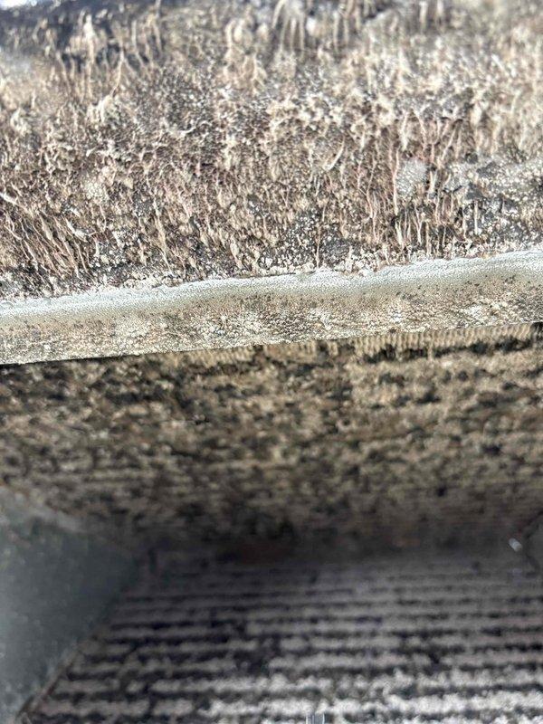 Performed system pump down and removed evaporator coil for thorough cleaning due to heavy accumulation of dust, dirt, and debris that was significantly restricting airflow and reducing system efficiency. The coil fins were completely clogged with thick, matted contamination throughout all surfaces. After cleaning and reinstalling the coil, sealed the return ductwork to prevent future air leakage and restore proper system operation.