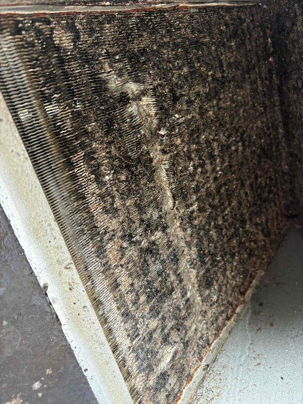 Performed system pump down and removed evaporator coil for thorough cleaning due to heavy accumulation of dust, dirt, and debris that was significantly restricting airflow and reducing system efficiency. The coil fins were completely clogged with thick, matted contamination throughout all surfaces. After cleaning and reinstalling the coil, sealed the return ductwork to prevent future air leakage and restore proper system operation.