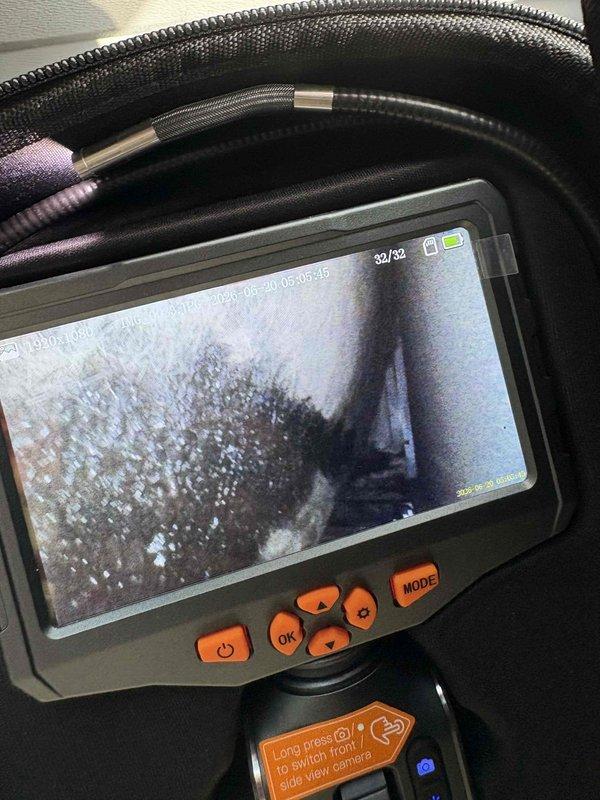 Responded to after-hours diagnostic call for AC system with inadequate airflow and cooling performance. Thermostat set to 68°F but indoor temperature reading 77°F. Performed visual inspection of ductwork system using borescope camera to identify airflow restrictions. Camera inspection revealed significant dust and debris accumulation within supply ductwork and interior duct surfaces showing signs of contamination. Documented findings with inspection photos showing buildup on duct interior walls and seams. System producing cool air but insufficient air velocity at registers. Identified likely cause as restricted airflow due to dirty ductwork and possible additional restrictions requiring further investigation. Contacted property manager with diagnostic findings and recommended duct cleaning service and full system evaluation to restore proper airflow and cooling capacity.