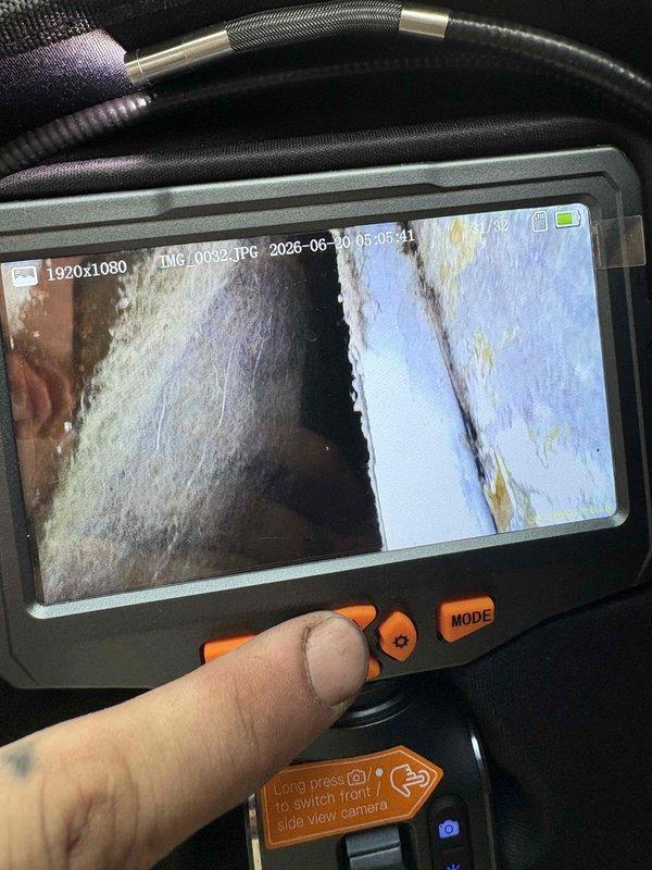 Responded to after-hours diagnostic call for AC system with inadequate airflow and cooling performance. Thermostat set to 68°F but indoor temperature reading 77°F. Performed visual inspection of ductwork system using borescope camera to identify airflow restrictions. Camera inspection revealed significant dust and debris accumulation within supply ductwork and interior duct surfaces showing signs of contamination. Documented findings with inspection photos showing buildup on duct interior walls and seams. System producing cool air but insufficient air velocity at registers. Identified likely cause as restricted airflow due to dirty ductwork and possible additional restrictions requiring further investigation. Contacted property manager with diagnostic findings and recommended duct cleaning service and full system evaluation to restore proper airflow and cooling capacity.