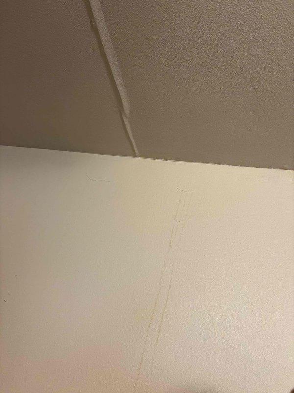 Responded to callback regarding ceiling leak in attic area following recent installation. Conducted thorough visual inspection of affected interior corners and wall-to-ceiling junctions. Documented water damage evidence including visible staining on wall surfaces and seam lines. Captured photographic documentation of compromised areas showing discoloration and moisture infiltration patterns at drywall joints for further assessment and warranty processing.