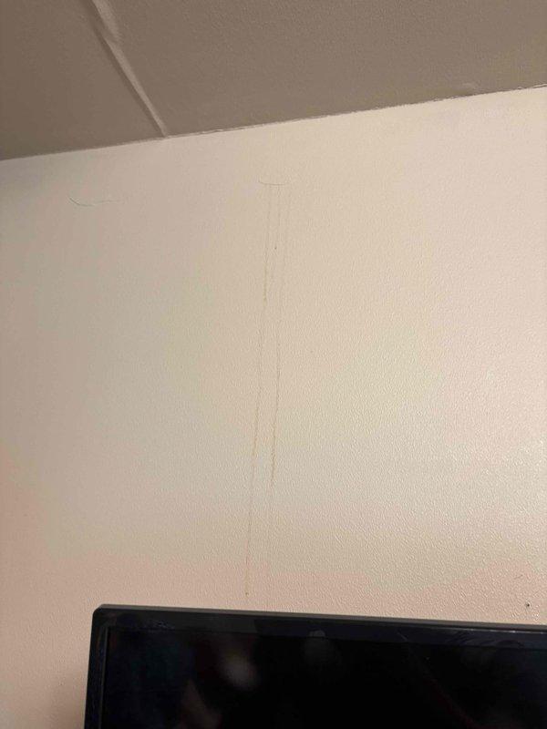 Responded to callback regarding ceiling leak in attic area following recent installation. Conducted thorough visual inspection of affected interior corners and wall-to-ceiling junctions. Documented water damage evidence including visible staining on wall surfaces and seam lines. Captured photographic documentation of compromised areas showing discoloration and moisture infiltration patterns at drywall joints for further assessment and warranty processing.