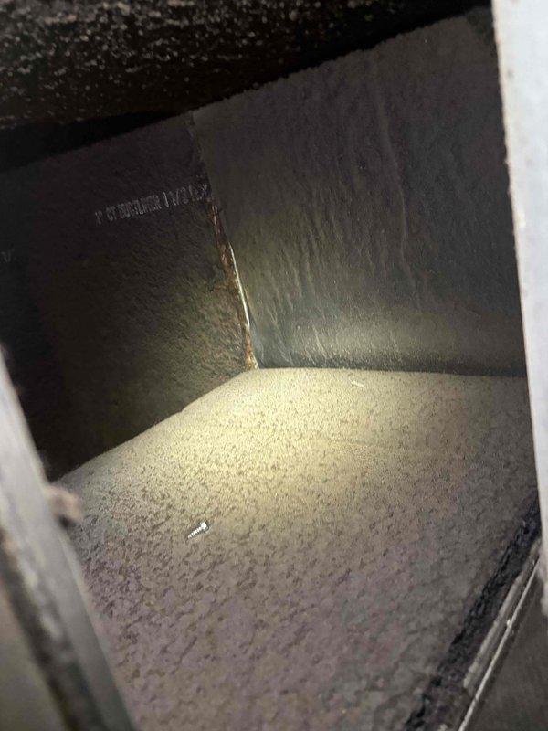 Responded to no cooling complaint on approximately 20-year-old HVAC system. Upon arrival, confirmed unit was not producing cool air with thermostat calling for cooling and fan operating. Performed diagnostic inspection of system components including ductwork and electrical connections. Observed significant dust and debris accumulation in air duct system affecting airflow efficiency. Inspected condensate drain system and verified no refrigerant line freezing present at time of inspection. Assessed overall system condition and identified age-related wear on unit components requiring further evaluation for proper cooling restoration.