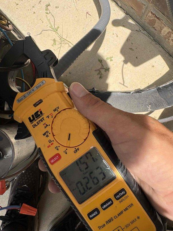 Responded to no cooling complaint on first floor front zone following weekend electrical outages. Upon arrival, confirmed air handler operational but outdoor condensing unit failed to start. Performed electrical diagnostics at condenser using clamp meter to measure voltage and amperage at compressor and motor terminals. Testing revealed inadequate voltage supply and zero amperage draw, indicating loss of power to unit. Measured line voltage at disconnect and compressor contactor to isolate electrical fault. Findings consistent with control circuit failure or contactor malfunction preventing compressor operation. Documented electrical readings and equipment conditions for repair recommendations.