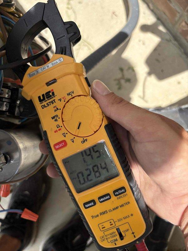 Responded to no cooling complaint on first floor front zone following weekend electrical outages. Upon arrival, confirmed air handler operational but outdoor condensing unit failed to start. Performed electrical diagnostics at condenser using clamp meter to measure voltage and amperage at compressor and motor terminals. Testing revealed inadequate voltage supply and zero amperage draw, indicating loss of power to unit. Measured line voltage at disconnect and compressor contactor to isolate electrical fault. Findings consistent with control circuit failure or contactor malfunction preventing compressor operation. Documented electrical readings and equipment conditions for repair recommendations.