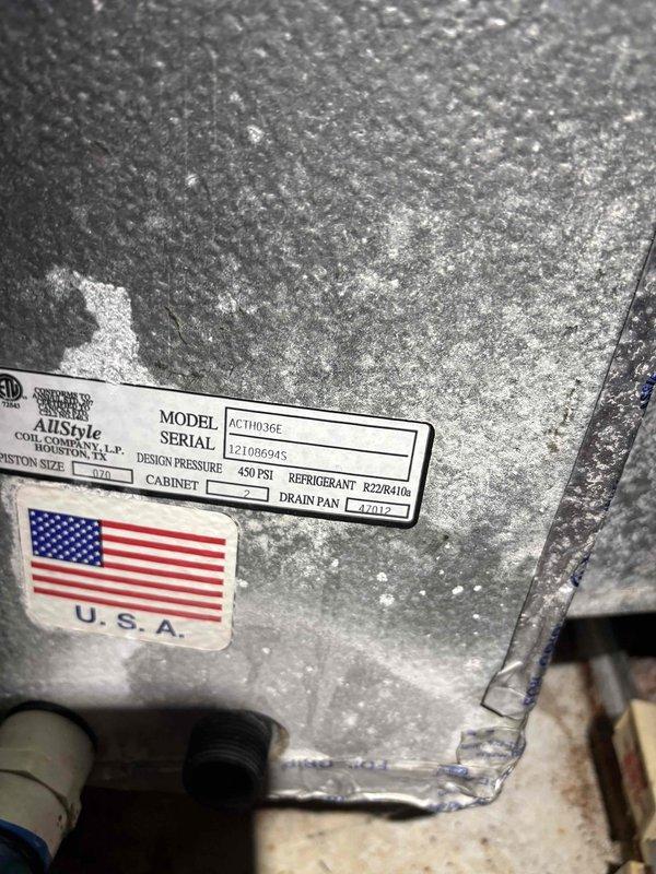Responded to no cooling complaint on 2013 R22 system with condenser and coil replaced in same year. Performed diagnostic evaluation and electrical measurements using clamp meter on outdoor unit. System assessed for refrigerant charge levels due to suspected low freon condition. Unit specifications confirmed as R22 refrigerant system with significant dust accumulation on cabinet surfaces noted during inspection.