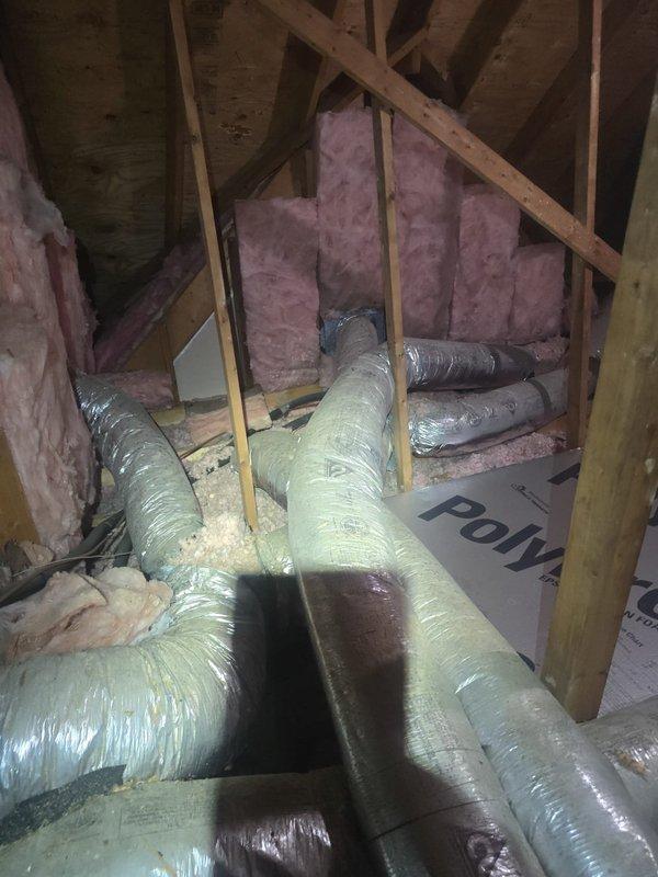 Conducted attic inspection and provided estimate for ductwork replacement and repair. Documented existing HVAC duct system showing aged flexible ductwork with visible wear, discoloration, and compromised insulation wrapping throughout the attic space, requiring replacement to restore proper system efficiency and air distribution.