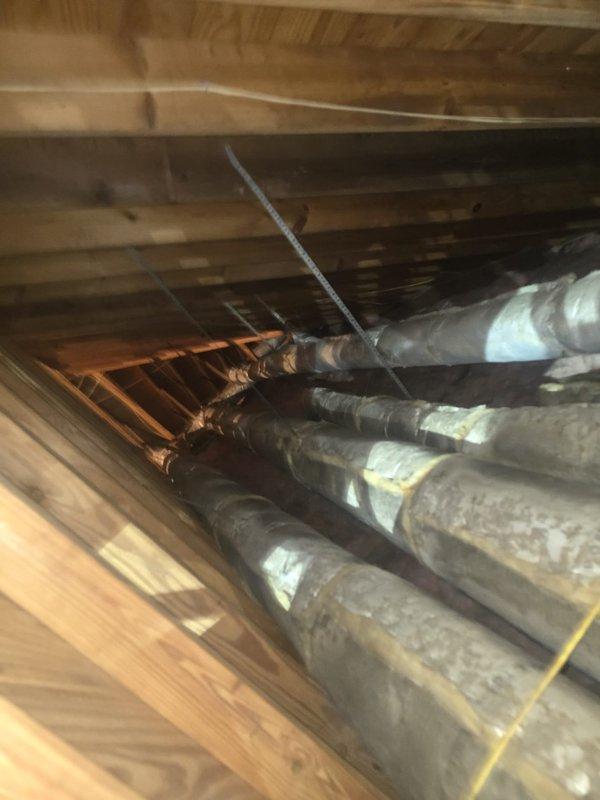 Completed full HVAC system replacement with Amana high efficiency equipment over two-day installation period. Removed existing system and installed new furnace, air handler, and condensing unit with associated ductwork modifications visible in crawl space area. New copper refrigerant lines and insulated supply ducts were installed alongside existing wooden structural members, with all work completed to code requirements and passing rough-in inspection. System includes 10-year parts and labor warranty.