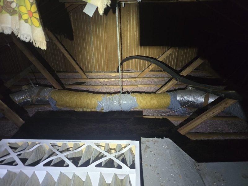 Responded to service lead for major evaporator coil leak in air handler system. Conducted thorough inspection of attic-mounted HVAC equipment and documented existing ductwork configuration, including flexible and rigid duct connections. Assessed air handler unit condition, measured duct dimensions for replacement specifications, and photographed affected components. Prepared comprehensive estimate for evaporator coil replacement and submitted documentation for approval.