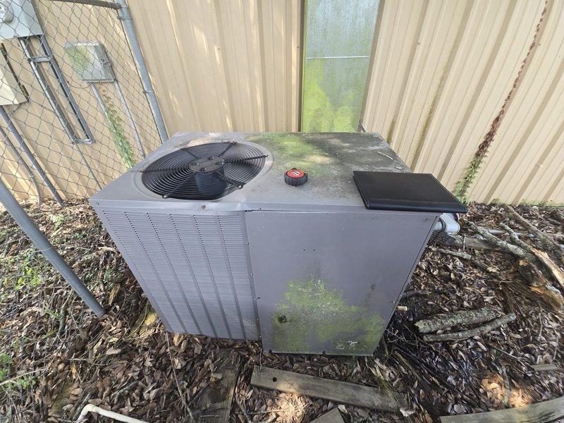 Conducted on-site evaluation of residential HVAC system to provide replacement estimate. Assessed existing outdoor condensing unit showing significant weathering, biological growth, and deterioration from extended environmental exposure. Documented current system configuration and measured installation space requirements, noting 30-inch clearances and dimensional constraints for equipment replacement. Photographed unit condition and recorded technical specifications to prepare comprehensive replacement proposal.