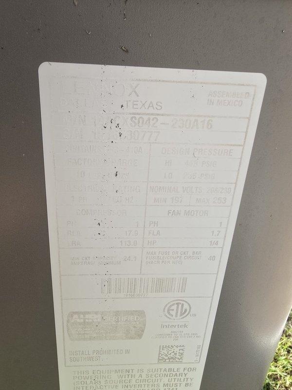 Conducted on-site evaluation of residential HVAC system including exterior condensing unit and attic ductwork installation. Documented equipment specifications for Texas-branded SD42-23A018 model unit with 208-230V electrical requirements, 1-phase operation, and AHRI certification. Inspected attic space to assess flexible duct routing, insulation conditions, and overall system configuration for estimate preparation. Photographic documentation captured for technical review and proposal development.