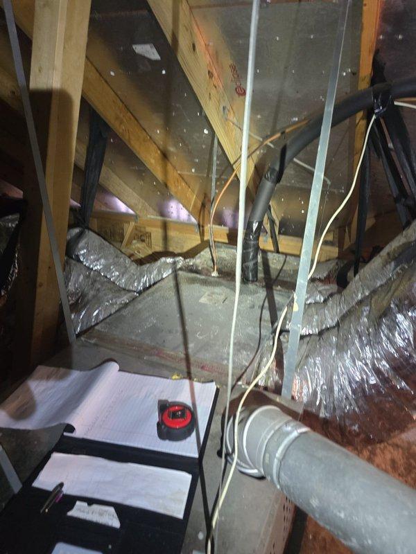 Conducted on-site evaluation of residential HVAC system including exterior condensing unit and attic ductwork installation. Documented equipment specifications for Texas-branded SD42-23A018 model unit with 208-230V electrical requirements, 1-phase operation, and AHRI certification. Inspected attic space to assess flexible duct routing, insulation conditions, and overall system configuration for estimate preparation. Photographic documentation captured for technical review and proposal development.