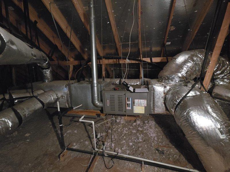 Assessed 13-14 year old 3.5 ton Lennox air conditioning system with failed compressor resulting in no cooling to primary residence. Customer currently utilizing mini split units for temporary climate control while evaluating options to coordinate home warranty claim payout toward new system replacement. Documented existing attic-mounted air handler installation and ductwork configuration, recorded equipment specifications and measurements for replacement system sizing considerations.