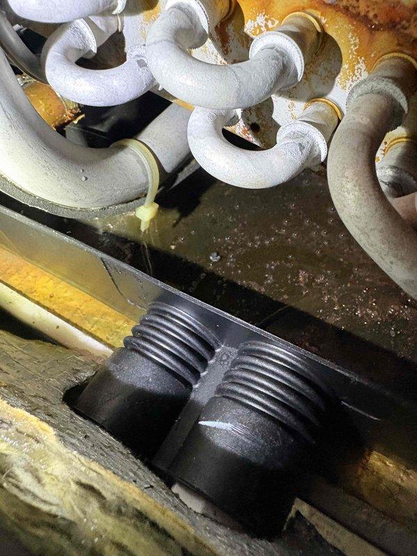 Performed comprehensive air conditioning system inspection in response to concerns about potential refrigerant loss and standing water in drain pan. Found blower wheel assembly heavily coated with dust and debris accumulation, which restricts airflow and reduces system efficiency. Observed standing water in condensate drain pan with visible rust staining and discoloration on metal surfaces, indicating ongoing drainage issues. Documented refrigerant line insulation condition and condensate trap assembly. Customer has been manually removing water with shop vacuum due to drainage system not functioning properly. Recommended thorough blower wheel cleaning, condensate drain line clearing, and system refrigerant charge verification to restore proper operation.