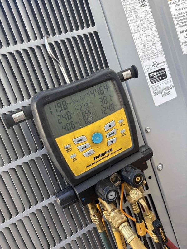 Responded to recurring "99-High Torque Lockout" system fault on downstairs front air conditioning unit. Performed comprehensive diagnostic testing using digital manifold gauges and temperature sensors to evaluate system performance. Measured refrigerant pressures, superheat, and subcooling readings across the system. Analyzed compressor operation and electrical parameters. Inspected condenser coil condition and refrigerant lines for restrictions or abnormalities. System readings showed temperatures of 198°F, 248°F, and 359°F at various test points, with operating pressures of 177 PSIG on high side. Documented all diagnostic findings with photographic evidence of equipment readings and system conditions for further analysis of intermittent fault condition occurring around 6:00-6:15 PM timeframe.