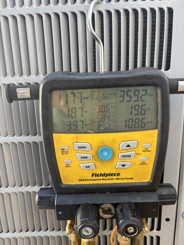 Responded to recurring "99-High Torque Lockout" system fault on downstairs front air conditioning unit. Performed comprehensive diagnostic testing using digital manifold gauges and temperature sensors to evaluate system performance. Measured refrigerant pressures, superheat, and subcooling readings across the system. Analyzed compressor operation and electrical parameters. Inspected condenser coil condition and refrigerant lines for restrictions or abnormalities. System readings showed temperatures of 198°F, 248°F, and 359°F at various test points, with operating pressures of 177 PSIG on high side. Documented all diagnostic findings with photographic evidence of equipment readings and system conditions for further analysis of intermittent fault condition occurring around 6:00-6:15 PM timeframe.