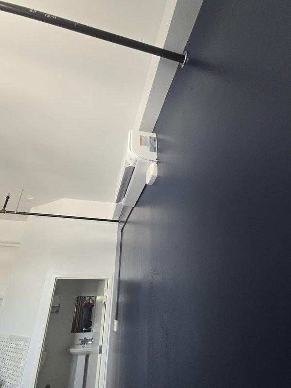 Provided labor-only installation estimate for customer-supplied ductless mini-split systems. Site assessment completed for two interior locations: main living area with existing wall-mounted unit and upper-level attic space with sloped ceiling configuration requiring careful placement considerations for optimal airflow and drainage routing.