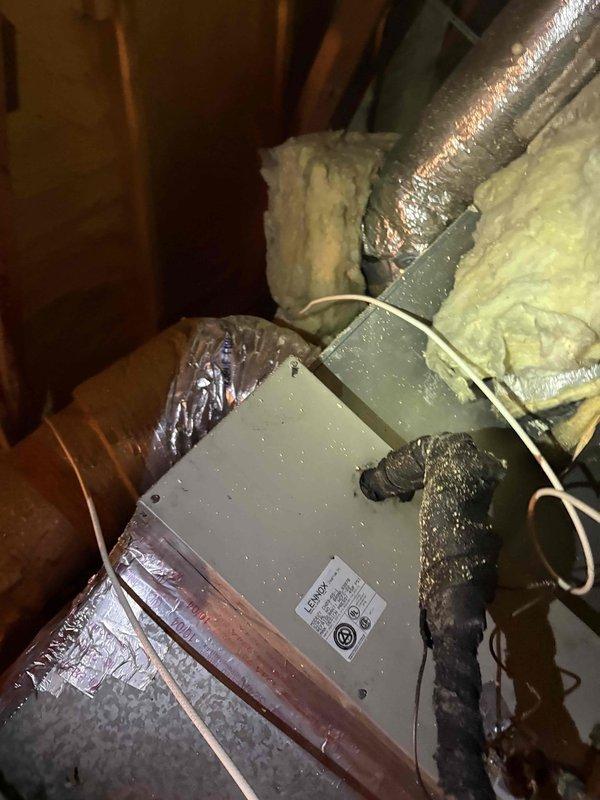 Responded to after-hours diagnostic call for frozen refrigerant line. Upon arrival, customer reported line had been frozen but was nearly thawed. Inspected HVAC system in attic space and observed significant condensation present on air handler unit and flexible ductwork surfaces. Connected Fieldpiece SMAN digital manifold gauges to system and recorded temperature and pressure readings across multiple zones to assess system performance and identify cause of freeze condition. Instructed customer to operate system fan to complete defrosting process and allow proper airflow circulation. Documented system conditions with photos showing gauge readings and condensation on equipment for further evaluation of potential airflow restriction, refrigerant charge issues, or thermostat cycling problems that may have contributed to coil freezing.
