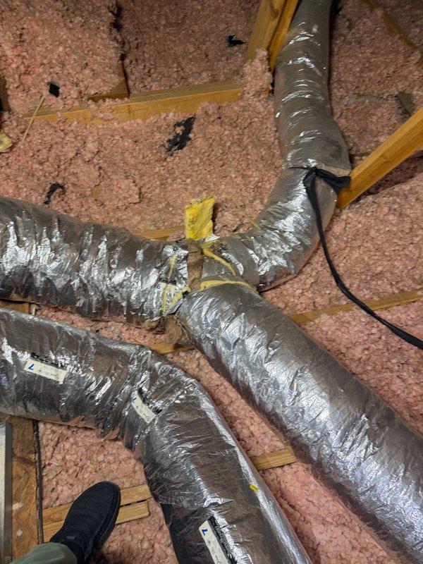 Completed small HVAC installation in vacant residential attic space, including flexible ductwork routing and connection to existing system. Installed and secured metallic flex ducts with proper support strapping, sealed all connections with mastic and foil tape, and verified proper placement over existing fiberglass insulation to maintain thermal efficiency.