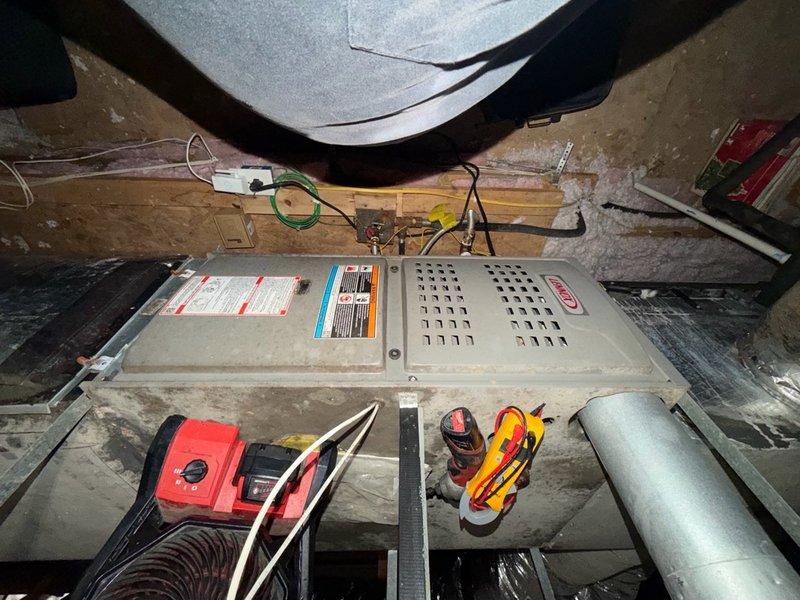 Installed new float switch in attic-mounted HVAC system. Verified proper electrical connections and tested system operation with multimeter to confirm float switch functioning correctly at 4.9 amp draw. System operational and ready for service.