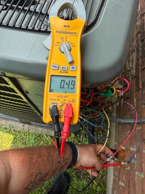 Installed new float switch in attic-mounted HVAC system. Verified proper electrical connections and tested system operation with multimeter to confirm float switch functioning correctly at 4.9 amp draw. System operational and ready for service.