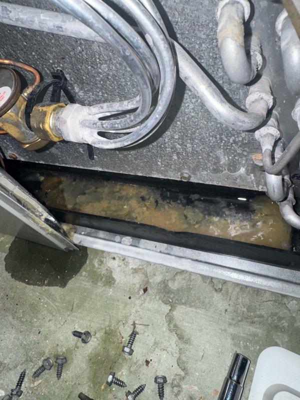 Responded to callback for downstairs AC unit displaying system offline status due to drainage issue. Upon arrival, accessed unit and identified clogged condensate drain line preventing proper system operation. Cleared blockage from PVC drain line and verified proper drainage flow. Inspected drain pan for standing water and confirmed pan was draining correctly after clearing obstruction. Checked refrigerant lines and connections for any secondary issues. Cycled system on to verify unit came back online and resumed normal cooling operation. Left work area clean and advised proper system function restored.