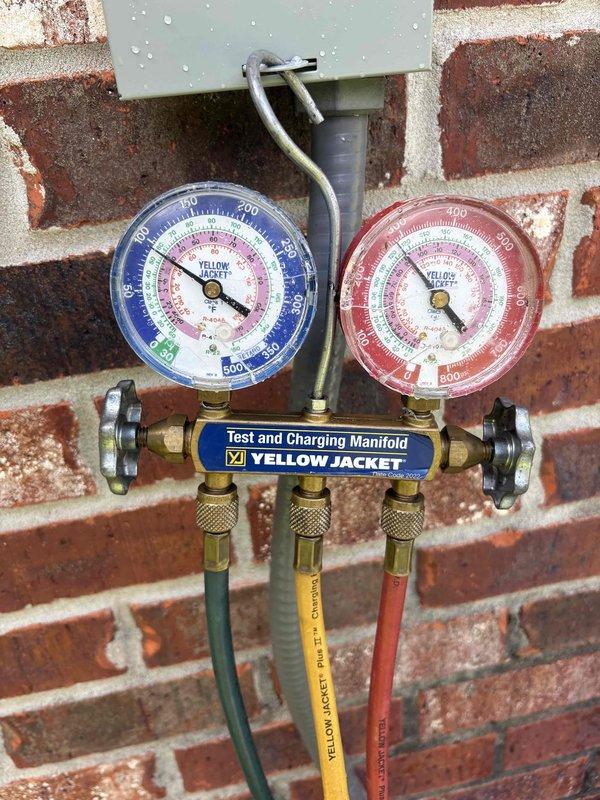 Responded to no cooling complaint on 2001 Rheem R22 system following reported power outage. Performed diagnostic evaluation and connected manifold gauges to verify refrigerant pressures. System confirmed to be critically low on R22 refrigerant, corroborating previous assessment. No evaporator coil icing observed, condensate pan dry, electrical supply verified at breaker. Presented findings and repair options to customer for approval before proceeding with any corrective action.