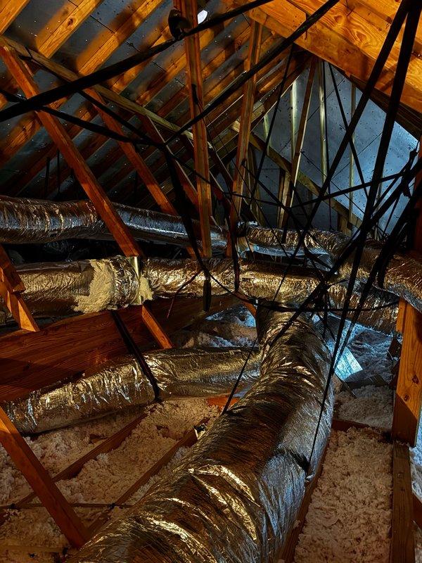 # Large HVAC Installation - Attic Ductwork Assessment and Correction Plan

Conducted comprehensive evaluation of newly installed HVAC ductwork system in residential attic space. Inspection revealed multiple deficiencies requiring immediate attention to ensure proper system performance and efficiency.

## Primary Issues Identified

**Airflow Restrictions:** Discovered flexible ductwork installed with excessive kinking and compression throughout attic space. Multiple duct runs improperly routed, creating sharp bends and restrictions that significantly impede airflow and reduce system capacity. Documented improper installation techniques affecting overall HVAC performance.

**Return Air Leakage:** Identified unsealed return air collars at multiple connection points. Gaps at collar interfaces allowing hot attic air infiltration into return air stream, compromising system efficiency and indoor air quality. This condition forces system to condition unconditioned attic air, increasing energy 