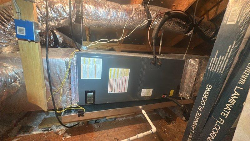 Responded to after-hours service call for no cooling condition. Initial phone troubleshooting identified tripped breaker; system restored to operation upon resetting breaker. Follow-up call received reporting unit running but delivering warm air with no temperature reduction. Performed on-site diagnostic inspection of air handler unit located in attic space. Evaluated system operation, refrigerant lines, electrical connections, and ductwork configuration to determine cause of insufficient cooling performance.