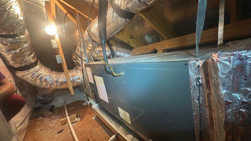 Responded to after-hours service call for no cooling condition. Initial phone troubleshooting identified tripped breaker; system restored to operation upon resetting breaker. Follow-up call received reporting unit running but delivering warm air with no temperature reduction. Performed on-site diagnostic inspection of air handler unit located in attic space. Evaluated system operation, refrigerant lines, electrical connections, and ductwork configuration to determine cause of insufficient cooling performance.