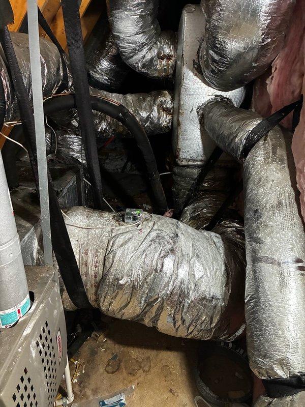 Completed medium-complexity HVAC installation involving ductwork modifications and UV light system integration in attic space. Installed flexible ductwork with reflective insulation material, routing multiple supply runs throughout the confined crawl space area while maintaining proper airflow paths and securing all sections with appropriate mounting brackets and straps. Connected ductwork to existing air handler unit, ensuring proper sealing and structural support to prevent sagging or compression. Integrated UV light system into the HVAC configuration per specifications. Coordinated delivery of 10x8 supply grills for final installation phase. All ductwork was properly insulated and secured to building framing members using black plastic strapping to maintain system integrity. Work completed in challenging attic environment with limited clearance, requiring careful navigation around existing pink fiberglass insulation and wooden structural elements. System tested for proper air distri