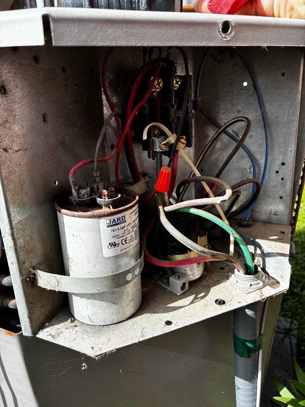 Performed comprehensive maintenance inspection on aging air conditioning unit with customer concerns regarding rattling noise and unit age assessment for property sale. Conducted thorough system evaluation including electrical components, capacitor testing, and internal component inspection. Cleaned condenser unit, checked all electrical connections and terminal blocks, verified capacitor functionality, and inspected wiring integrity throughout the system. Assessed overall unit condition and documented findings with detailed photographs of electrical panel, capacitor assembly, and internal components. Unable to determine exact unit age due to faded model and serial number plate. Identified rattling noise source and evaluated system performance. Provided customer with detailed assessment of current unit condition and recommended repairs needed for optimal operation.