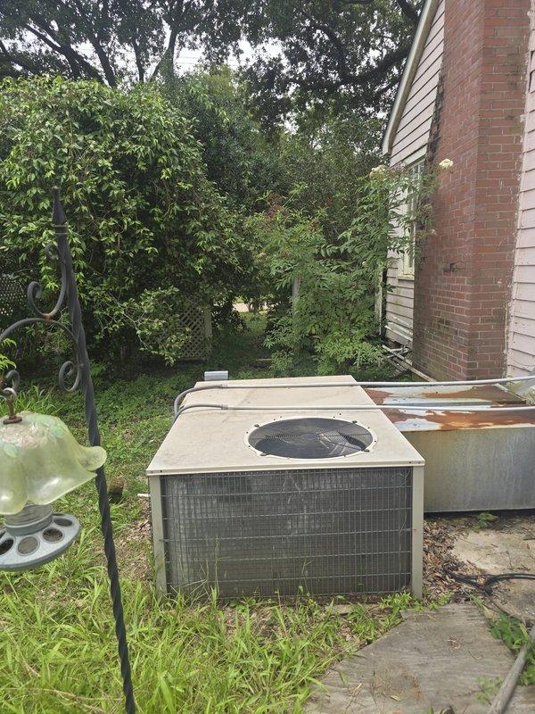 Completed installation of 3-ton gas heating and air conditioning system at residential property. Three-person crew removed existing HVAC equipment and installed new outdoor condenser unit on concrete pad adjacent to home exterior with proper clearances maintained. Unit positioned on level surface next to residential structure with brick chimney, ensuring adequate airflow and accessibility for future service. New system started up successfully, all operational parameters verified within manufacturer specifications, and installation documentation completed per standard procedures.