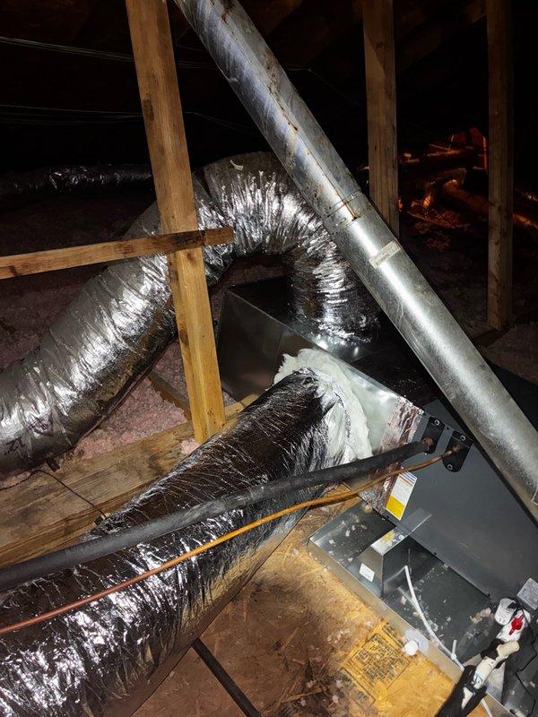 # Install - Large Completion Summary

Completed installation of 3-ton Amana evaporator coil replacement in attic space. Removed existing coil and installed new unit with supply plenum and return plenum modifications. Air handler positioned on OSB platform with proper clearances maintained for service access. Connected insulated flexible ductwork to new supply plenum, ensuring proper sealing at all connection points. Routed refrigerant lines and electrical connections per manufacturer specifications. Verified all ductwork connections secure and properly supported by wooden framing members. Installation includes updated labeling and warning placards on equipment. System positioned for optimal airflow distribution throughout residence with all components properly secured to structural framing.