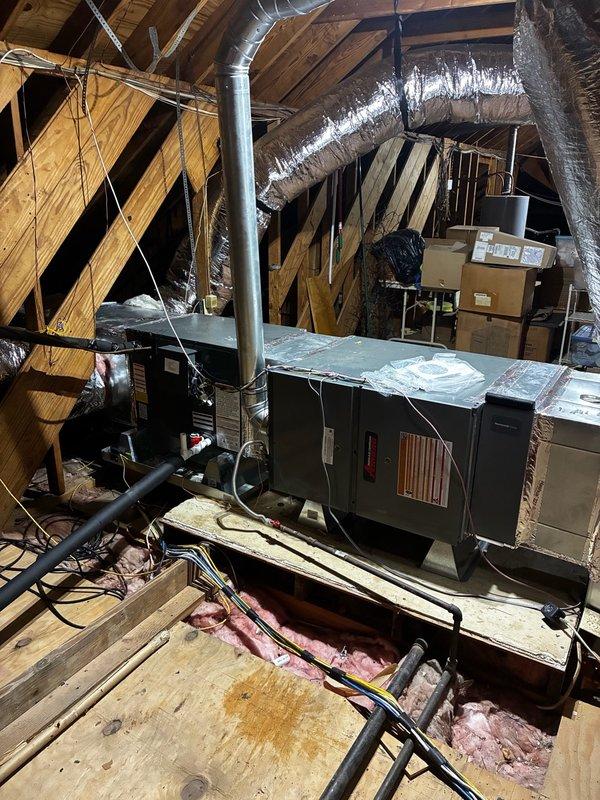 # Install - Small: HVAC System Completion

Completed final installation work on residential HVAC system in preparation for inspection. The scope included a complete air handler unit installation in the attic space with associated ductwork routing and connections.

## Work Performed

Installed central air handler unit on elevated platform in attic space with proper support and clearances for service access. Routed and secured multiple runs of insulated flexible ductwork throughout the attic, connecting supply and return air pathways to the air handler. Ductwork was properly supported on wooden structural members and secured to prevent sagging or disconnection.

Verified all duct connections were sealed and insulated flexible ducting was routed to minimize compression and maintain efficient airflow. Ensured adequate working clearances around equipment per manufacturer specifications and local code requirements.

Conducted final walkthrough and documentation of installation with photograp