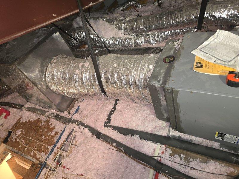 Conducted on-site consultation to assess residential HVAC system and discuss replacement options. Documented existing system configuration including attic-mounted air handler with flexible ductwork and fiberglass insulation, along with exterior condensing unit installed between property fences with electrical disconnect and refrigerant line set. Reviewed equipment condition and provided recommendations for system upgrades based on current installation parameters.