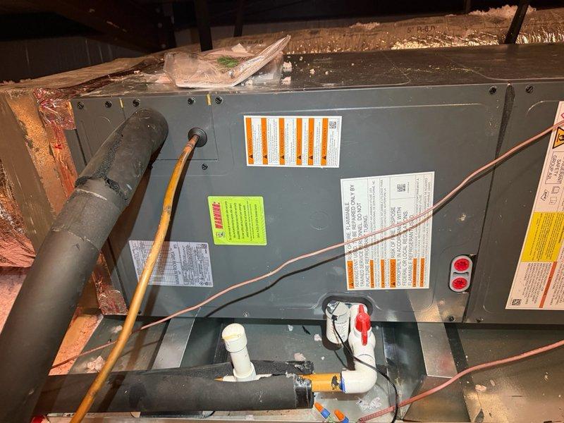 Completed full installation of a 2.5 ton economy electric HVAC system in attic space. Installed horizontal air handler unit with all required ductwork connections, copper refrigerant lines with proper insulation, PVC condensate drain piping with service valves, and Copeland electrical control module with complete wiring integration. All components installed to manufacturer specifications with proper labeling, system tested and confirmed operational.