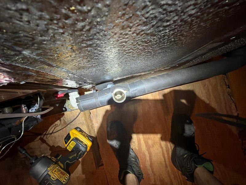 Responded to no-cooling call with elevated indoor humidity. Upon arrival, verified thermostat call for cooling with audible relay engagement at air handler, but confirmed outdoor condensing unit completely non-operational with no high voltage components energizing. Inspected crawl space and discovered severe condensation on metal ductwork and insulated refrigerant lines, indicating significant humidity infiltration in under-floor area. Measured and documented indoor humidity levels at supply registers. System was de-energized for safety pending further diagnosis of high voltage circuit failure at condensing unit. Documented conditions with photos showing extent of ductwork condensation and indoor humidity readings.