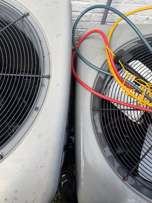 Completed medium-level installation service involving refrigerant addition and minor duct leak repairs on dual HVAC condenser units. Successfully addressed refrigerant deficiency by adding appropriate charge to system and performed necessary repairs to resolve minor ductwork leakage issues. Both Rheem condenser units are now operational and properly charged, with all refrigerant lines connected and secured between the two systems installed on exterior concrete pads.