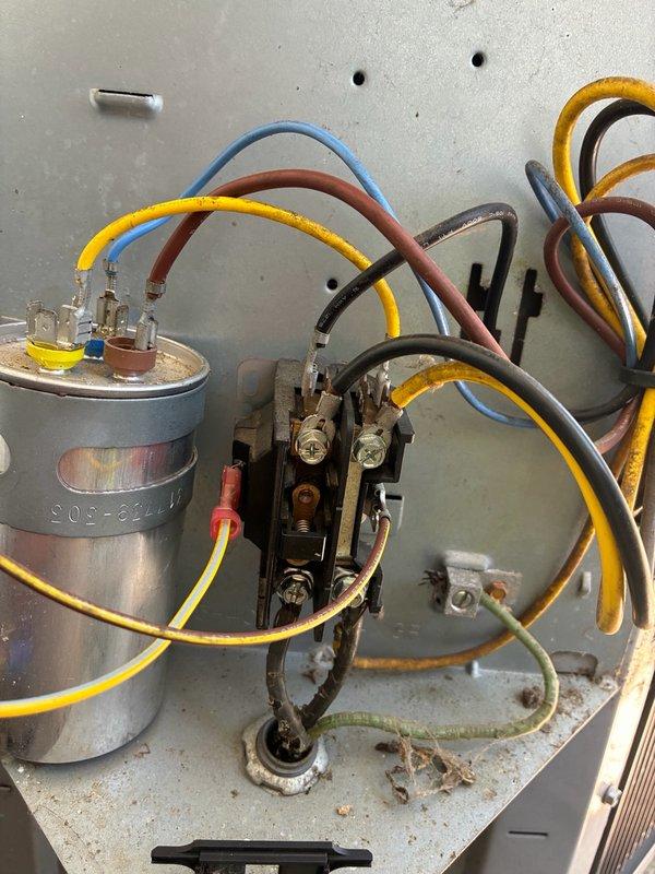 Responded to no-cooling call on residential HVAC system. Customer reported outdoor condenser fan not operating on one of two systems. Upon arrival, performed visual inspection of outdoor unit electrical components and identified failed dual-run capacitor. Conducted thermal imaging scan of affected area to verify temperature differentials and confirm lack of compressor operation due to capacitor failure. Documented existing wiring configuration showing connections between capacitor, contactor, and system components. Advised customer of findings and provided repair options to restore system functionality.