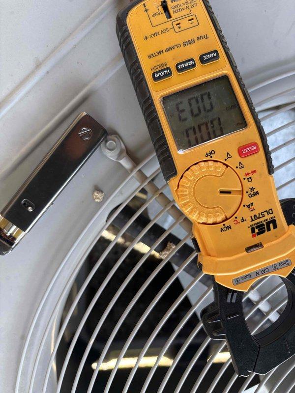 Responded to no-cooling call for downstairs system in dual-system residence. Upon arrival, confirmed condenser fan motor was inoperative while compressor attempted to run. Performed diagnostic testing using digital multimeter to verify electrical supply and motor functionality. Testing revealed condenser fan motor had failed and was not receiving proper voltage due to motor winding failure. Unit is original equipment, approximately 7 years old. Explained findings to customer and provided options for repair, including fan motor replacement to restore system operation.